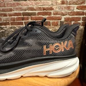Hoka Black and Gold Athletic Shoes